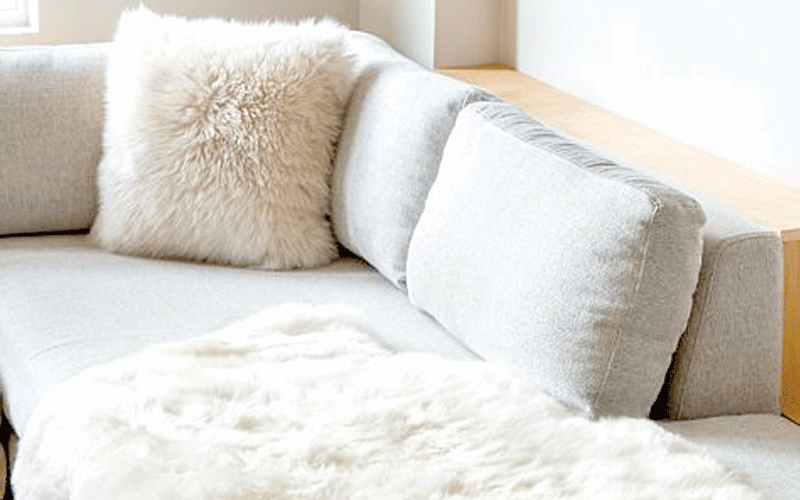 sheepskin rug on leather sofa