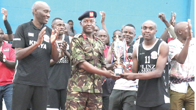 KPA basketball team led by captain Eric Mutoro receives a trophy from Colonel Victor Mburu after being crowned 2021 champions. pd/ DAVID NDOLO