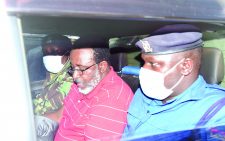 Meru Senator Mithika Linturi sandwiched between policemen upon a recent arrest over hate speech allegations. DCI officers have sought orders to exhume the body of a former househelp. PHOTO/FILE
