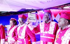 Presidential candidate Raila Odinga (centre) dons honorary regalia of minister of Apostolic Council Around the Globe Deliverance Ministries. With him is Apostle Francis Musili (left) and Apostle Nicholas Ikui at the church in Embakasi. PD/KENNA CLAUDE