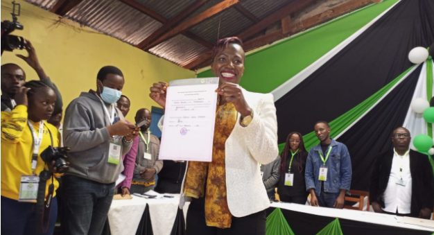 Beatrice Njeri Maina displays her certificate after being declared the winner for Murang'a woman representative seat. 
PHOTO/Wangari Njuguna