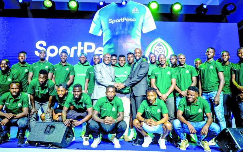 A section of Gor Mahia players and officials pose for a photo with SportPesa CEO after landing a Sh 80 million-a-month sponsorship deal on Friday. PHOTO/PD/ DAVID NDOLO