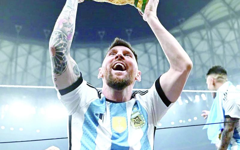 Lionel Messi lifts the World Cup trophy after he led Argentina to the title on Sunday night. PD/ COURTESY