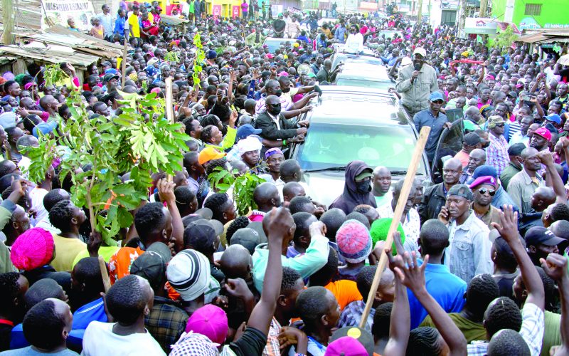 Residents of Kibera cheer as Azimio la Umoja leader Raila Odinga’s convoy snakes through the area. PD/ Emmanuel Wanson