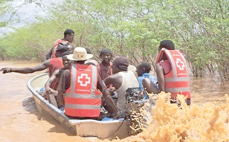 Kenya Red Cross volunteers and response personnel evacuate community members of Iftin Farm in Garissa county. The area was marooned by floods following heavy downpour throughout the weekend. PHOTO/Victor Ogalle