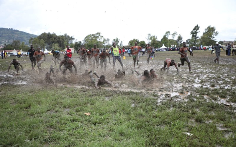 All Saints Boys High School players celebrate on a muddy pitch after winning the Rugby 15s national title at Machakos School. PHOTO/Phillip Kamakya